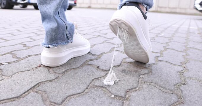 Man stepping into chewing gum on city street, closeup
