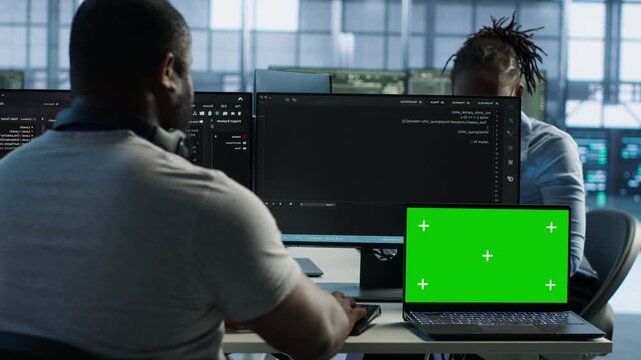 Data center isolated screen laptop next to programmer coding in server farm while highlighting configuration review, rackmount performance and network troubleshooting.