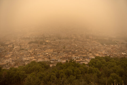 Aerial Panorama of Dense Tlemcen Cityscape Swallowed by Extreme Orange Dust Storm Haze