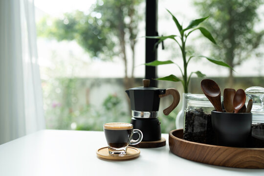 Coffee and moka pot set arranged on white table, morning relaxing routine