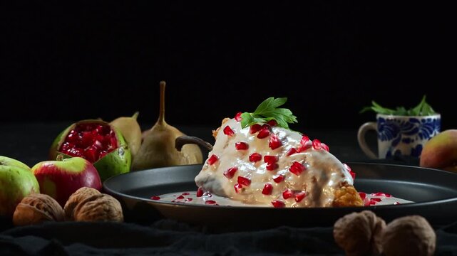 Rustic still life with fried poblano chili pepper (chile en nogada) fresh fruits and walnuts on dark surface