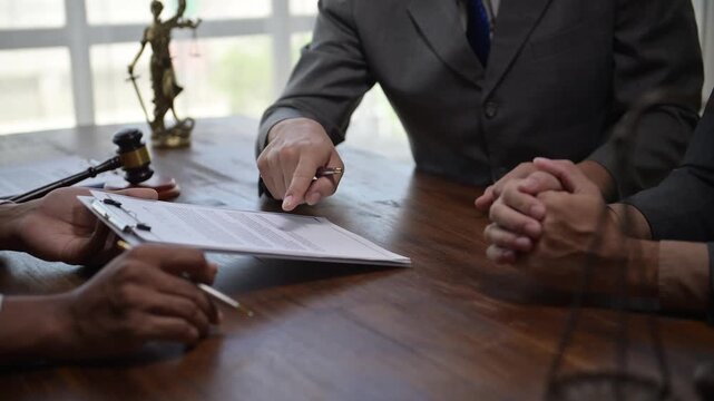Lawyers discussing contract details with client in office
