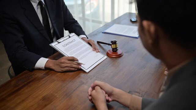 Lawyers discussing contract terms with client in office