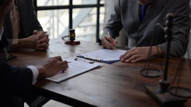 Business people negotiating a contract at law office