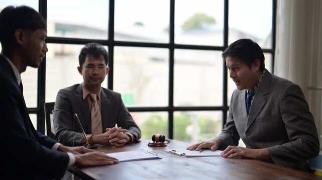 Businessmen signing contract and shaking hands in office