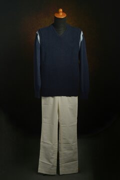 Men's fashion knitwear, navy vest over sweater on display mannequin