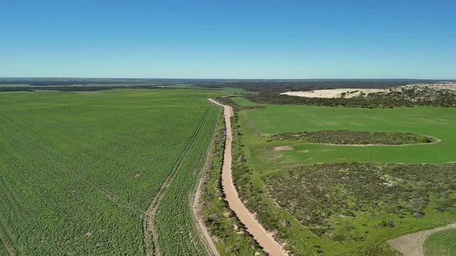 White Hut, Yorke Peninsula, South Australia &ndash; 4K aerial drone view of agricultural landscape, canola farms, contryside road, Daly Head National Surfing Reserve, rocky coastline.