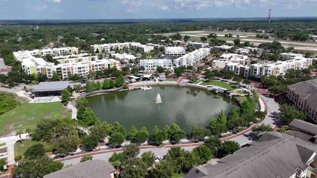 Multiple apartment complexes surrounding Center Lake Park at downtown Oviedo in Seminole County, Florida.