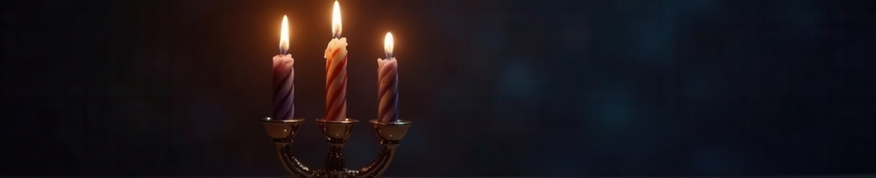 A menorah with two brightly burning candles against a dark background Second night of Hanukkah , festival of lights, silver