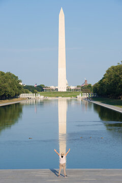 An unidentified woman tourist and Washington D.C., skyline, including major monuments - Washington D.C. United States of America
