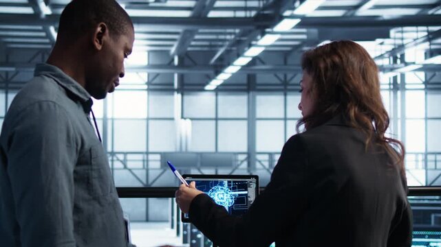 Data center manager uses documents in a server farm to review technical files and confirm a client agreement, combining document review, customer meeting and project approval.