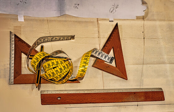 A collage of drafting tools and measuring instruments on a flat table surface