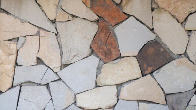 Close-up of irregular multicolored flagstone masonry wall texture