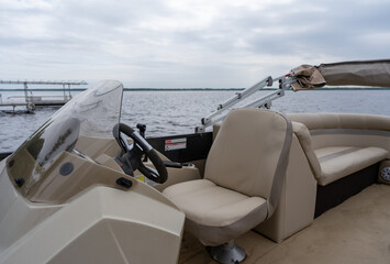 Captain's chair and helm of a modern pontoon boat © Olha Semeniv