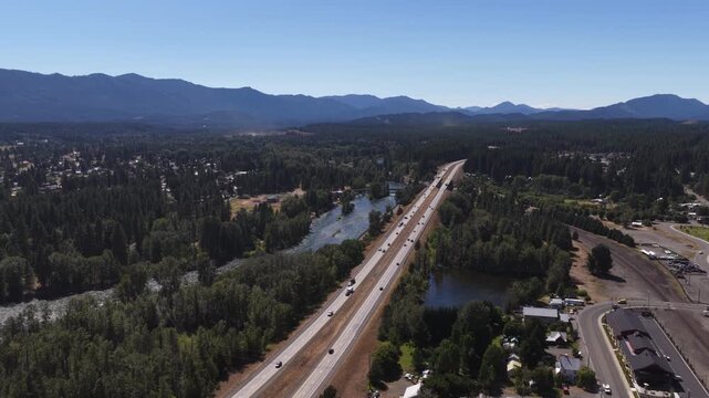 Aerial of highway I90 through forested valley in Cle Elum Washington with Yakima river in summer