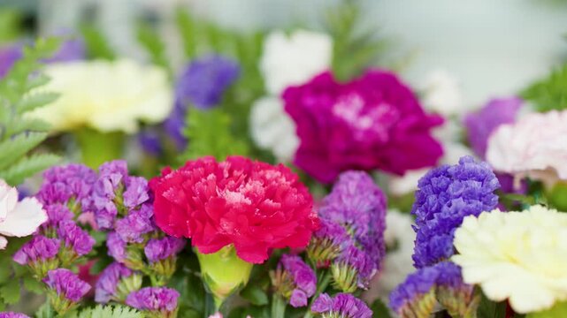 Vibrant Floral Arrangement with Pink Carnations and Purple Statice Flowers