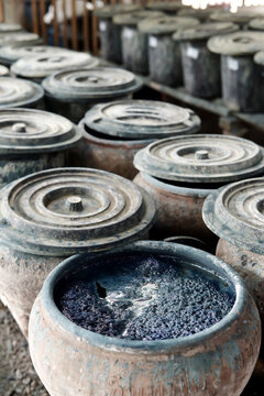 Fermenting natural indigo dye vat ready for hand-dyeing textiles in Sakon Nakhon, Thailand. Authentic craft.