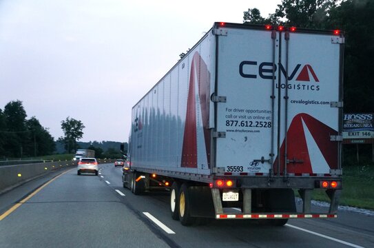 Pennsylvania, U.S.A - Jul 18, 2026 - CEVA Logistics semi-truck traveling at dusk with company branding and driver opportunity information on the trailer.