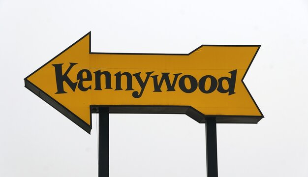 West Mifflin, Pennsylvania, U.S.A - July 18, 2026 - Large yellow Kennywood arrow sign pointing left against an overcast sky.