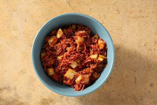 A top down view of a bowl of corned beef hash.