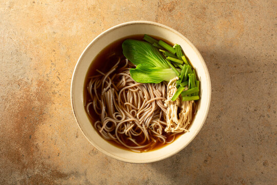 A top down view of a gluten-free soba noodle soup.