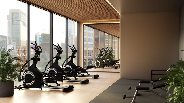 Modern fitness gym center with elliptical cross trainers and city view window
