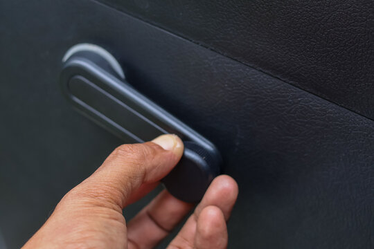 Operating Car Window Crank Handle.