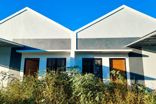 This minimalist house design is characterized by a gable roof without eaves.