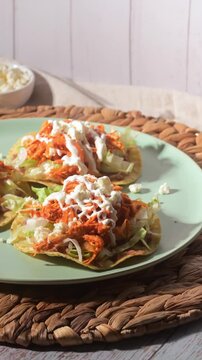 Traditional Mexican cuisine. Tasty chicken tinga tostadas on a plate. Direct flash video