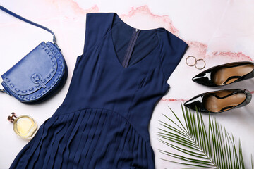 Obraz premium Composition with stylish female dress, shoes, accessories and palm leaf on light background