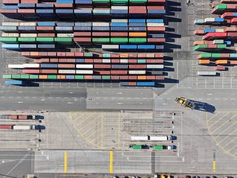 Cargo containers stacked in port yard aerial view