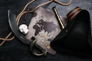 Pirate hat with map, skull, sword and rope on dark background © Pixel-Shot