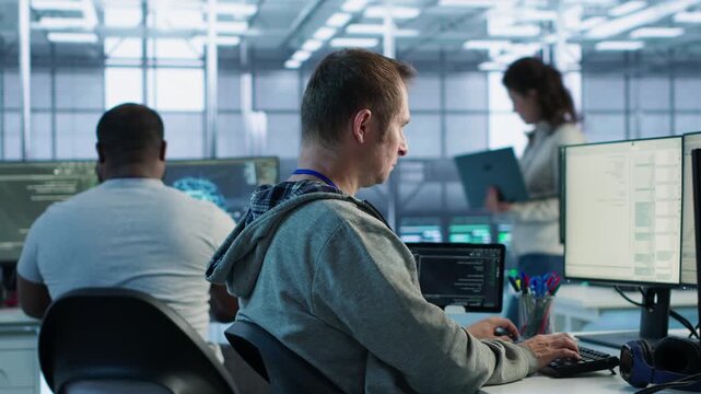 Data center manager admonishing programmer after making error in data center while showing secure storage, threat prevention and cybersecurity monitoring.