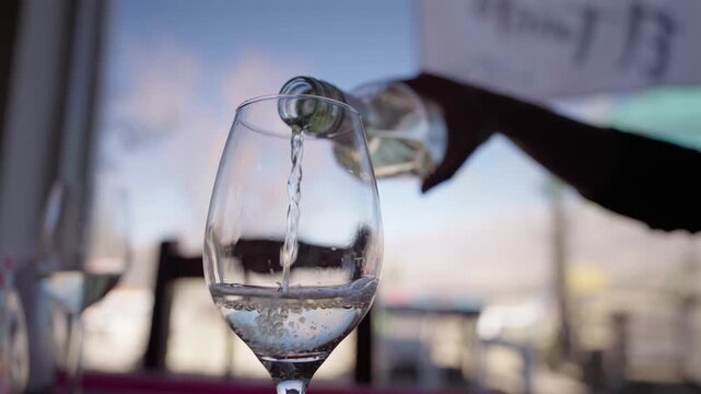 Close Up Pouring White Wine into Glass at Winery in Mendoza Argentina Wine Tourism and Tasting Experience