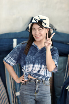 Asian woman in hand-dyed indigo shirt. Authentic Thai natural craft from Sakon Nakhon.