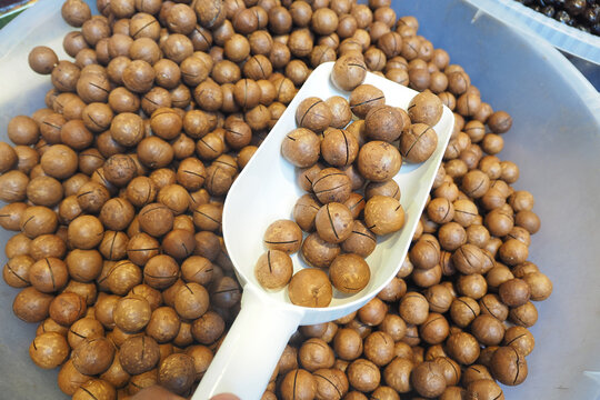 Bowl filled with many macadamia nuts at local market