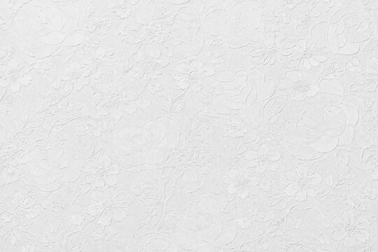 Elegant white embossed floral paper texture with delicate raised pattern, clean matte finish, and subtle handcrafted detail. Perfect for luxury stationery, packaging, backgrounds, and print design.