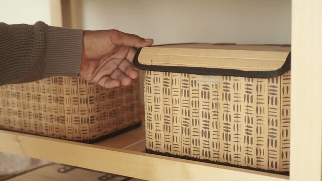 Storage baskets on a wooden shelf in a home setting
