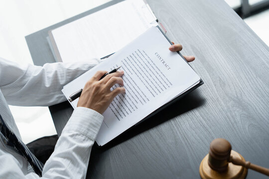 Lawyer reading legal document in office room