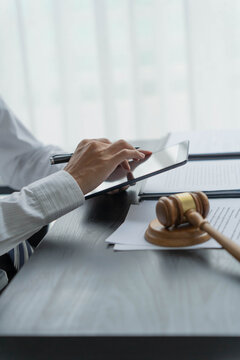 Lawyer using tablet checking legal document in office room