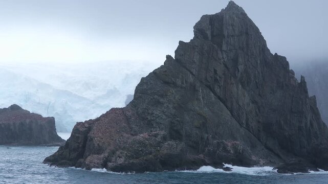 Antarctica Point Wild on Elephant Island Penguin Colony View From Cruise Ship. Moody Mist Background. Rock Formation Mountain Adventure Travel Wide