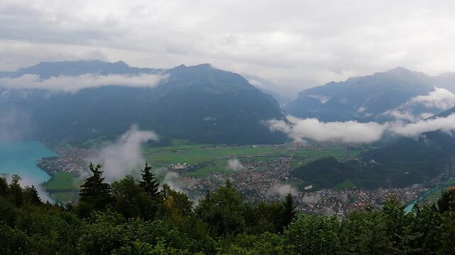 4K time-lapse of clouds drifting over Harder Kulm above Interlaken, Switzerland, showcasing dramatic alpine scenery, changing weather and panoramic Swiss Alps views.
