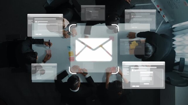 Aerial view of a team gathered around a table with digital communication tools and an email icon. This image depicts modern collaboration and efficiency in a business environment. Raster