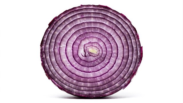 Crosssection of a vibrant red onion revealing concentric rings under bright studio lighting.