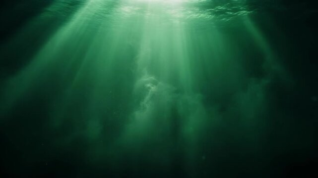 Green underwater scene with light rays penetrating through particles