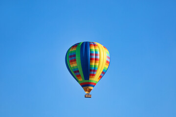 Fototapeta premium A bright colorful hot air balloon with clear blue sky in Temecula, California.