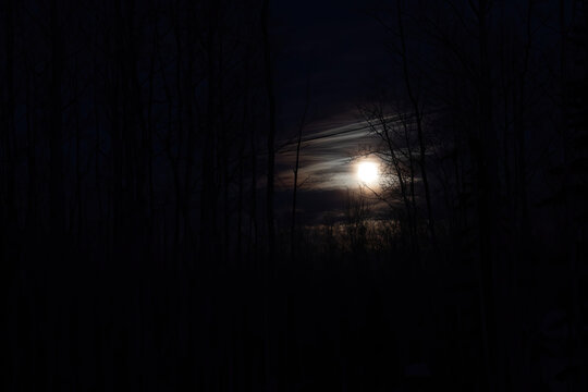 Full moon on a cloudy winter night in Alaska. 