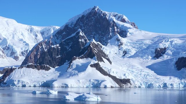 Cinematic Antarctica Mountain Covered in Snow and Glaciers. Stunning 4K Cruise Ship View Wide Clear Sunny Day in Wilhelmina Bay Calm Waters Blue Sky