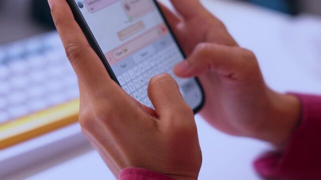 Smartphone hand message typing chat keyboard screen mobile communication closeup, touchscreen texting on mobile device, online chat concept with blurred keyboard background
