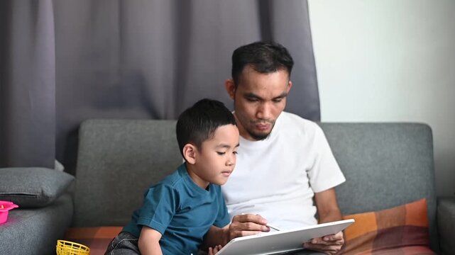Father and son Magnetic Drawing Board enjoy creative doodle and sketch activities at home.